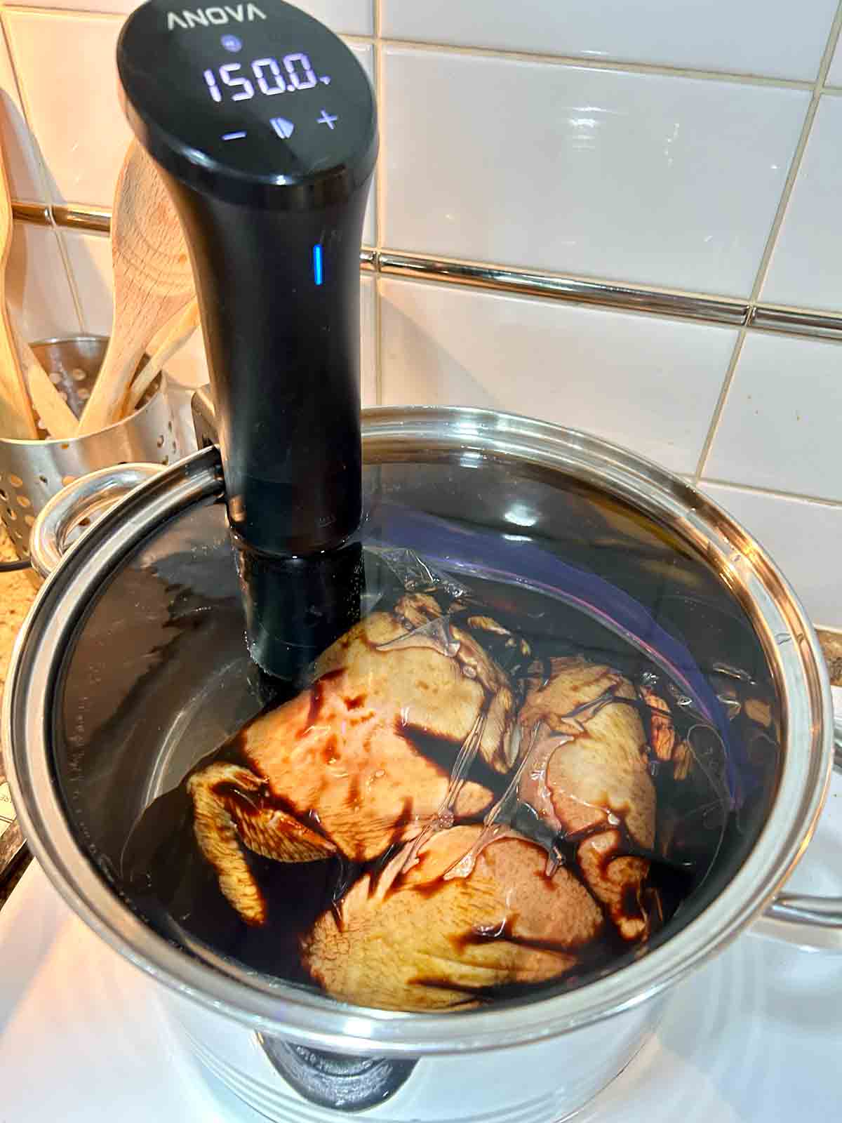 bag of chicken being cooked in water bath.