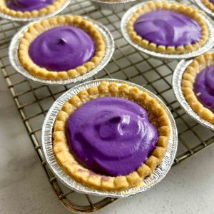 ube tarts on wire rack.