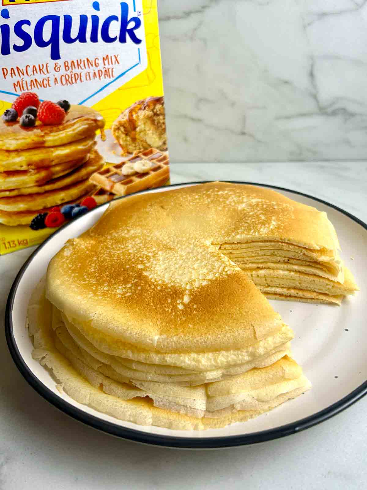 stack of crepes on a plate with a portion cut out, showing the cross-section.