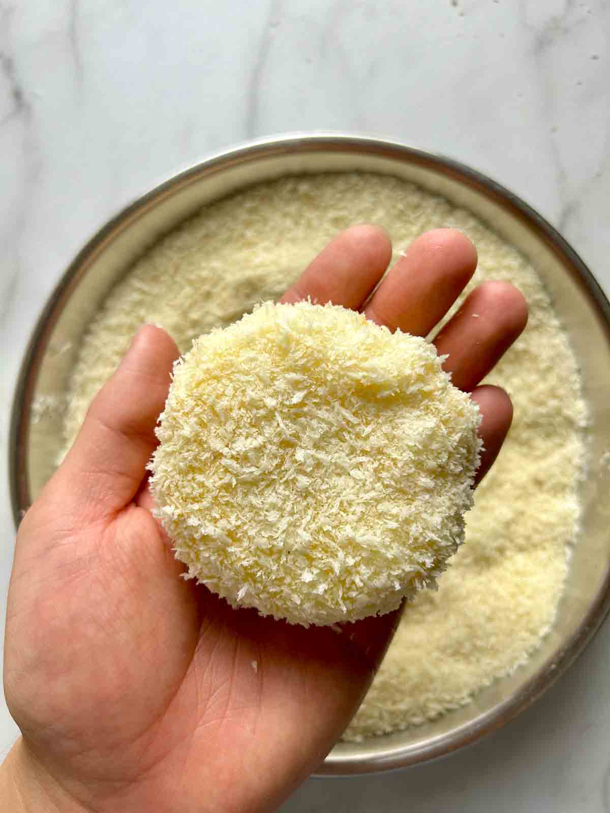 coating potato in breadcrumbs.