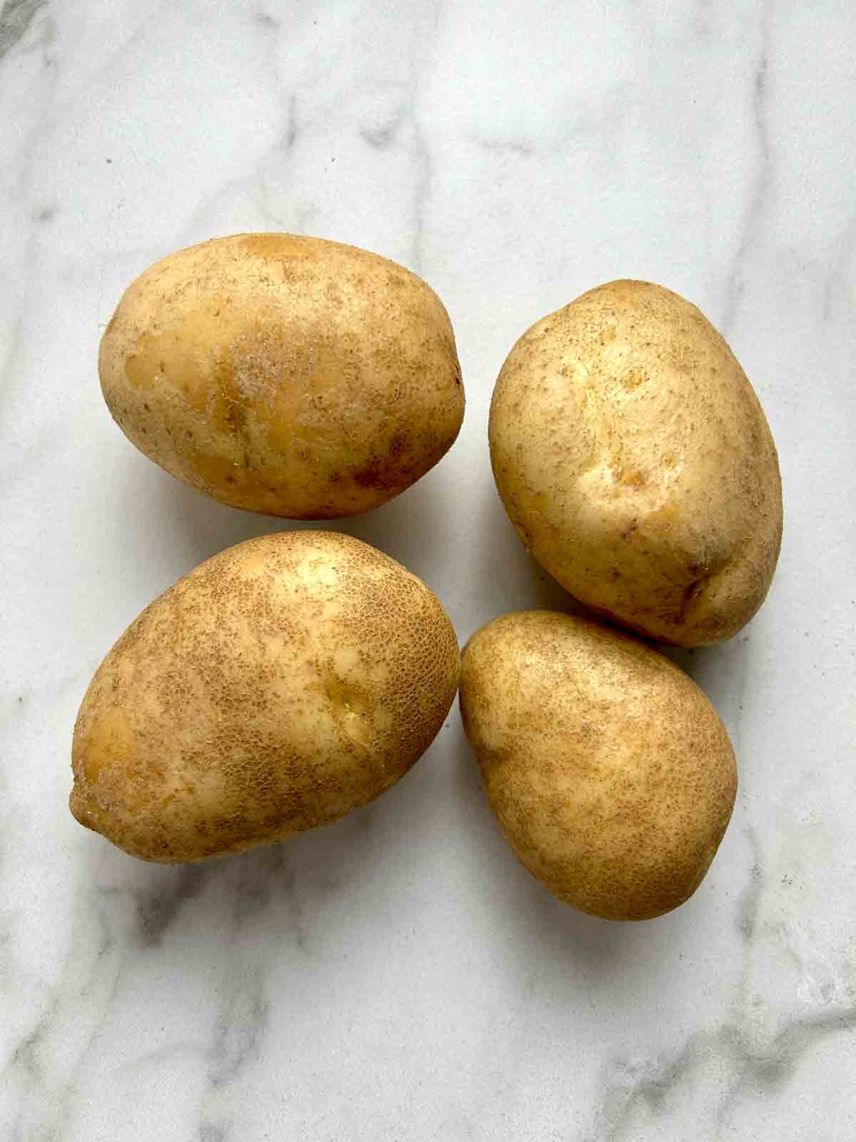 four Russet potatoes.