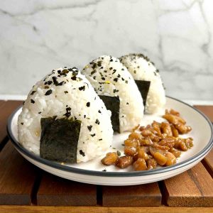 three chicken onigiri on plate with chicken filling.