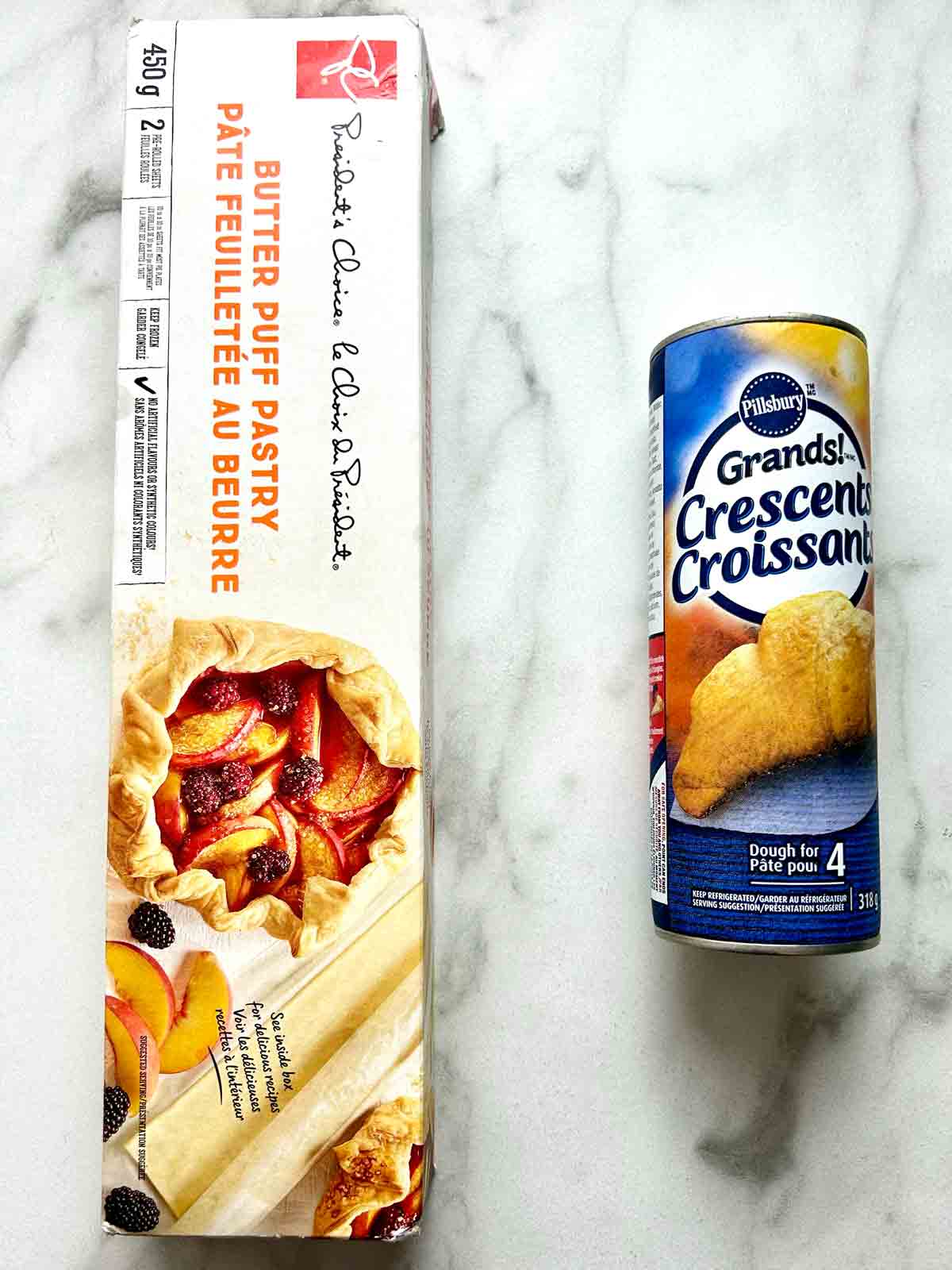 box of puff pastry next to tin of crescent roll dough.