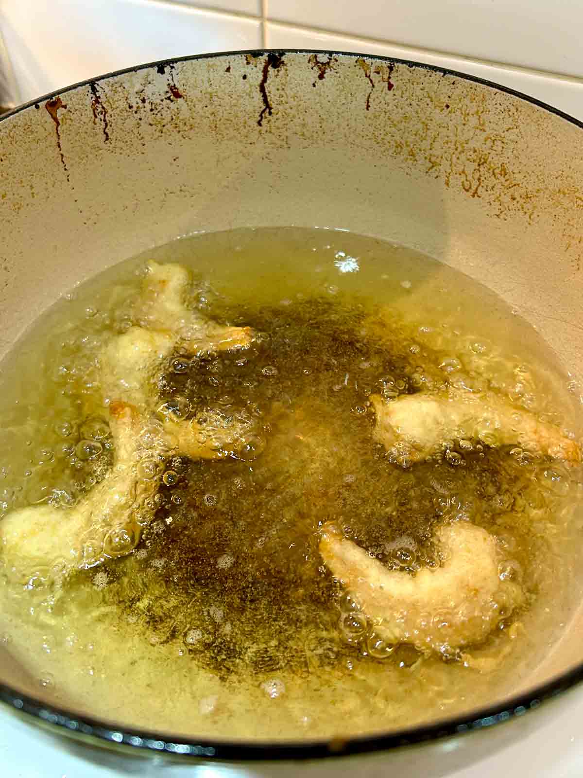 shrimp being fried in oil.