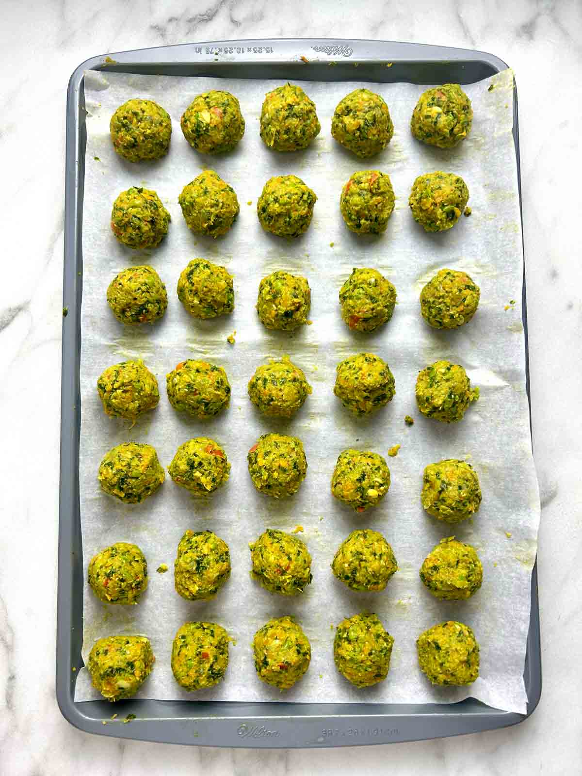 baking sheet of uncooked Ikea veggie balls.