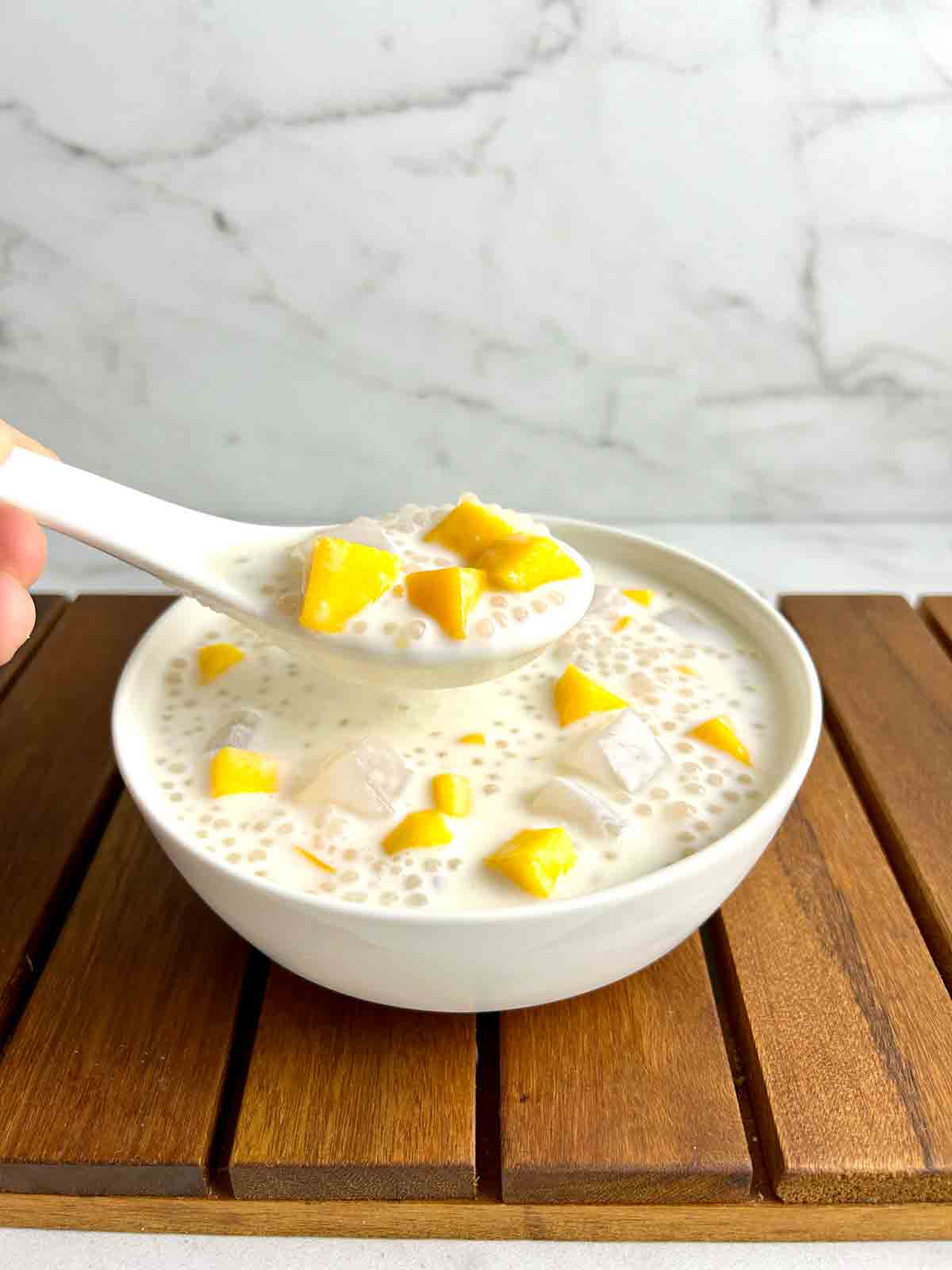 spoon lifting mango bango out of bowl.