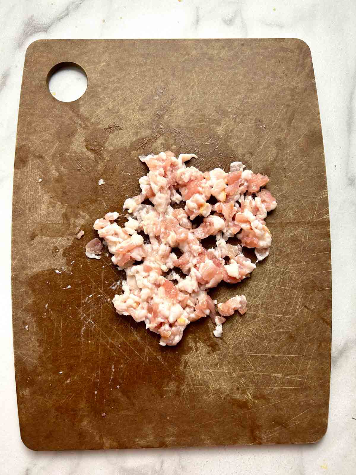 finely chopped bacon on cutting board.