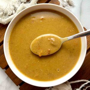 spoon lifting Popeye's cajun gravy out of bowl.