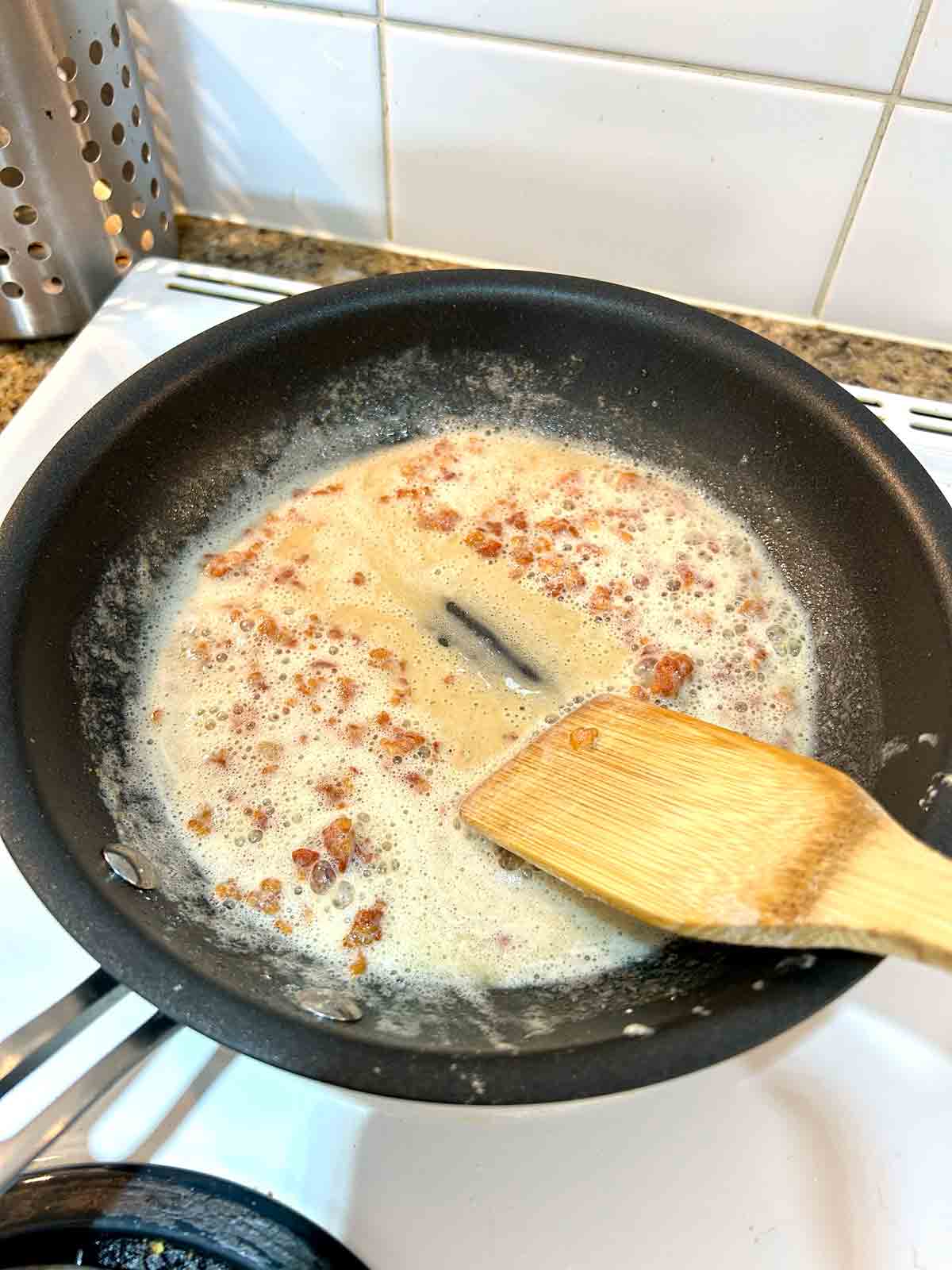 roux being cooked in pan.