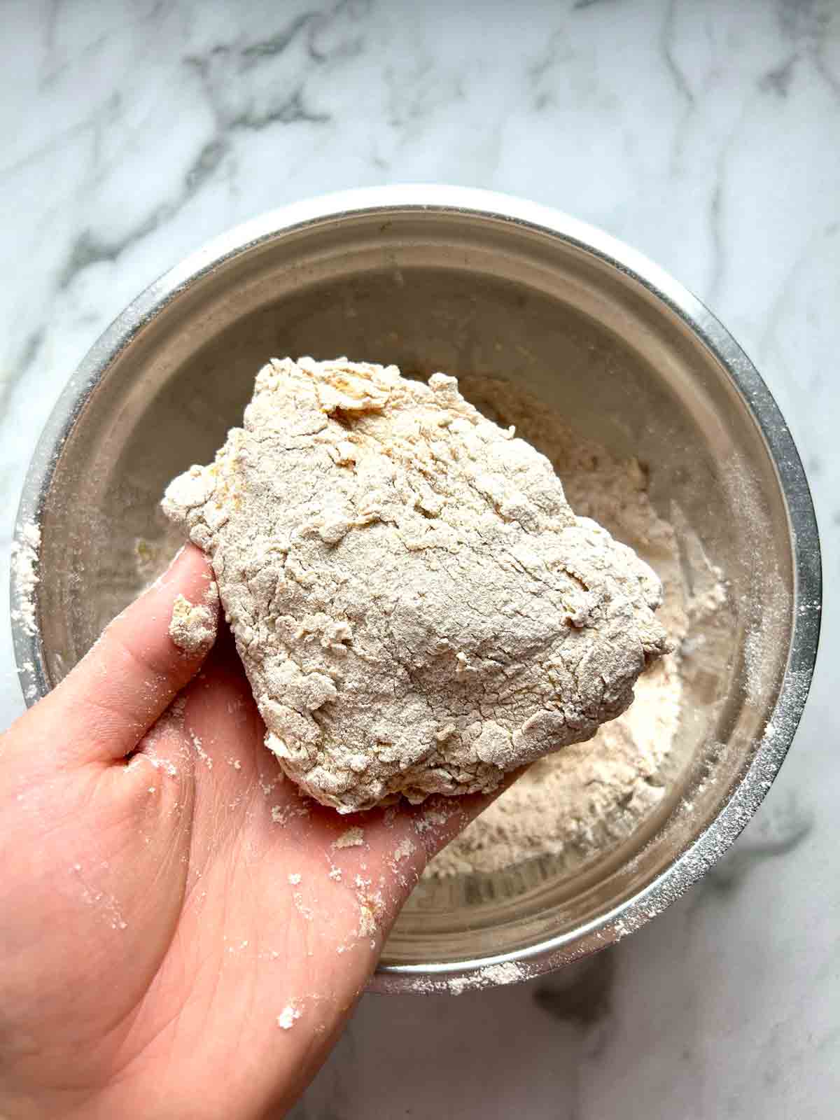 chicken being dredged in flour.