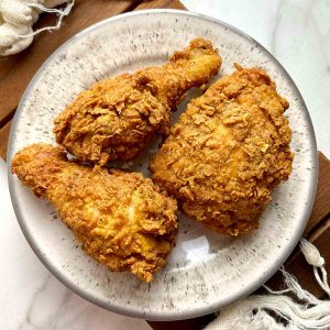 three pieces of Popeye's fried chicken on plate.