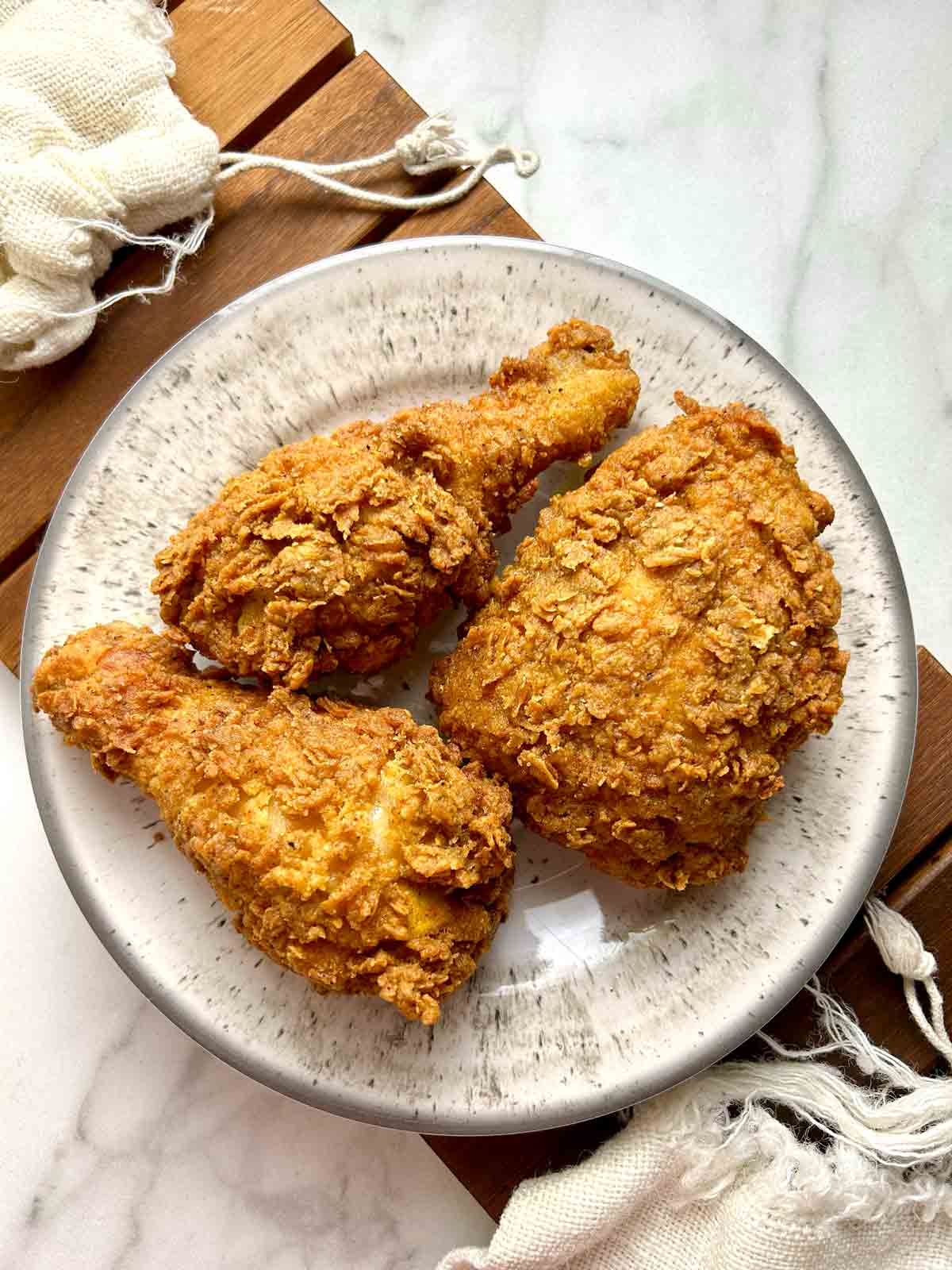 three pieces of Popeye's fried chicken on plate.