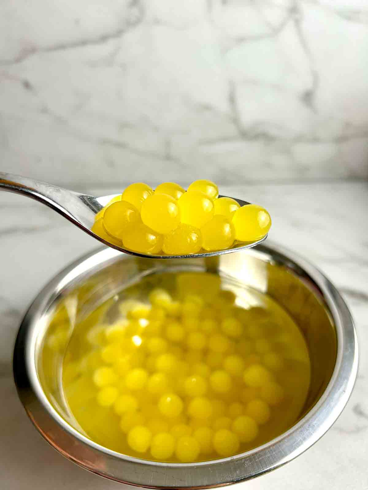 spoon lifting popping boba out of bowl.