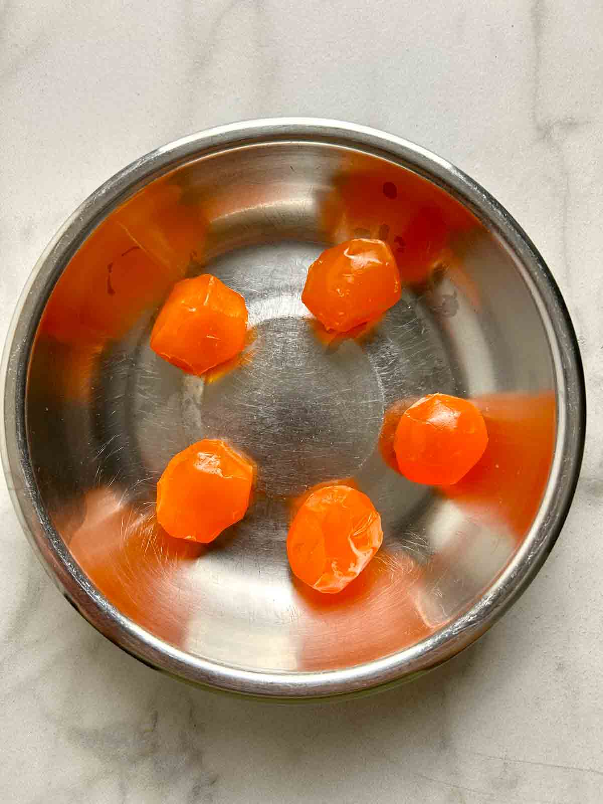 raw salted egg yolks in steaming dish.