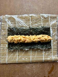 shrimp filling placed on sheet of nori.