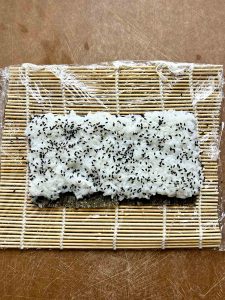 rice spread on piece of nori.