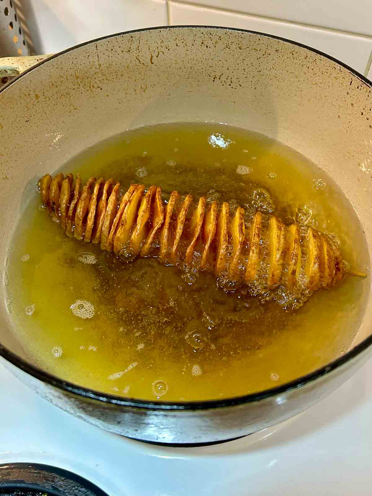 golden brown potato spiral after being fried for 4 minutes on each side.