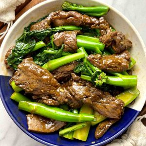 stir-fried beef and gai lan on plate.