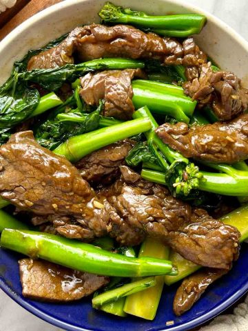 stir-fried beef and gai lan on plate.