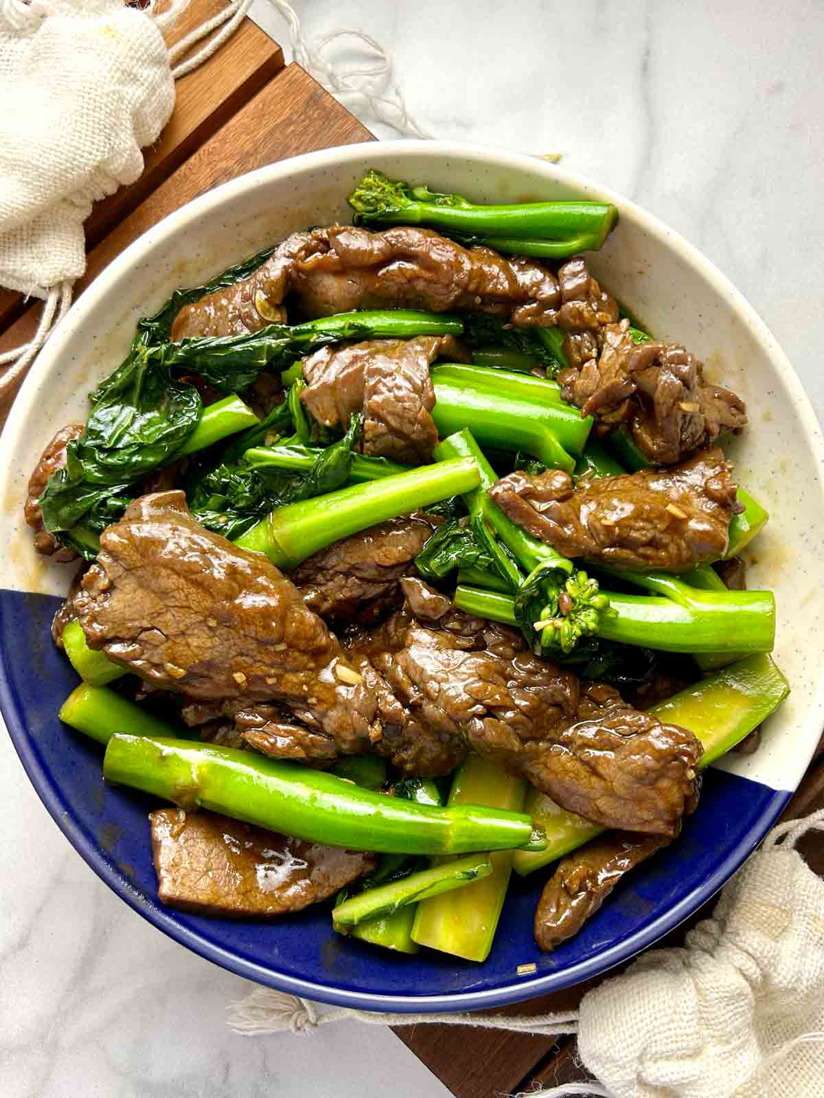 stir-fried beef and gai lan on plate.