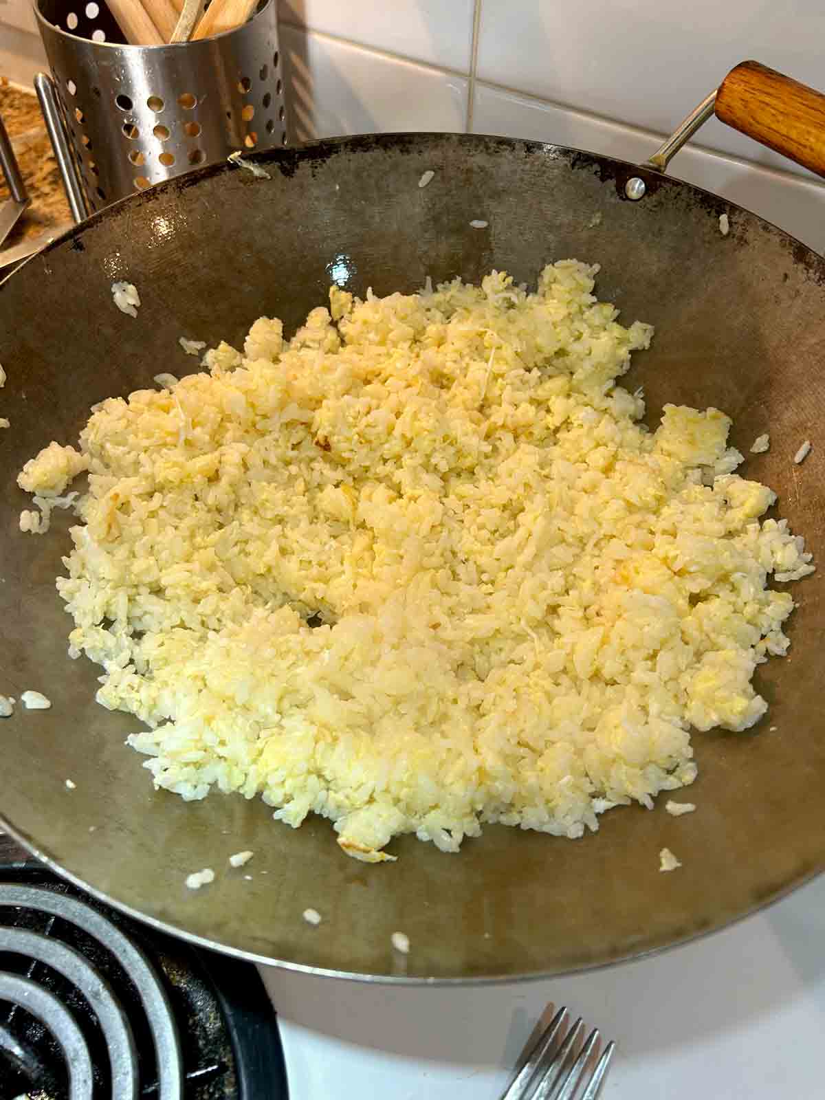 egg fried rice being cooked in wok.