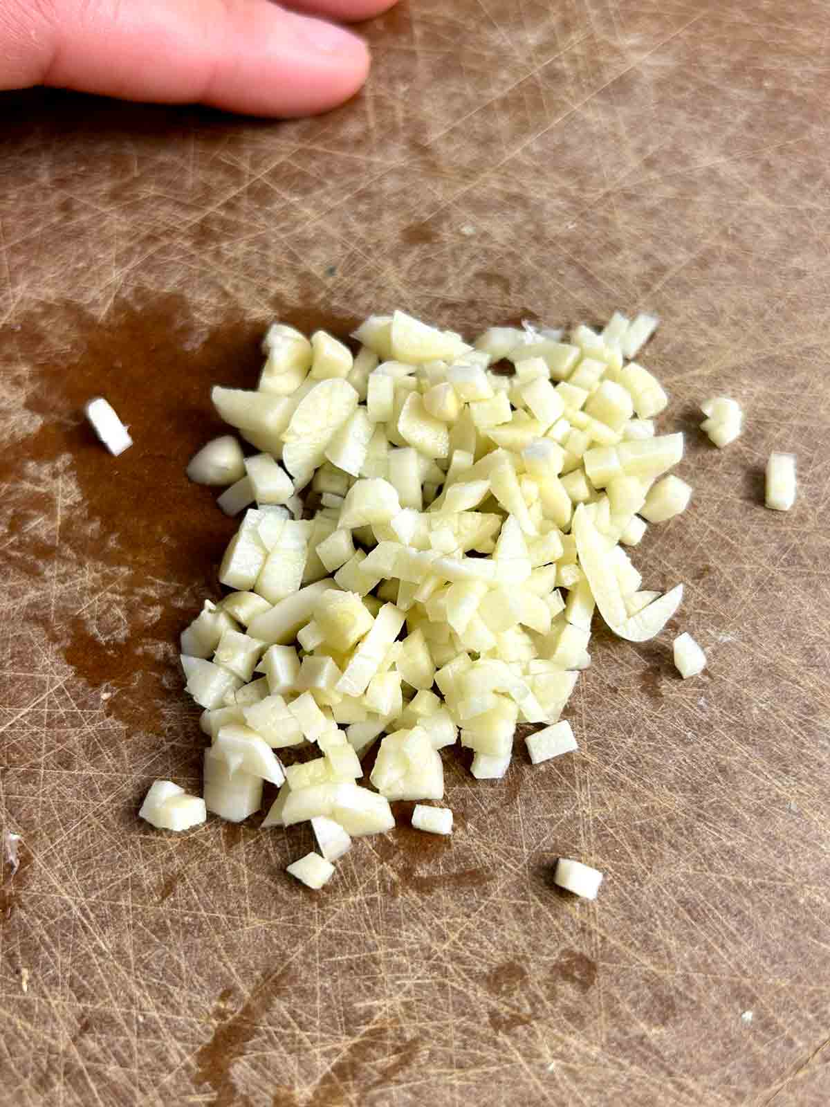 chopped garlic on cutting board.