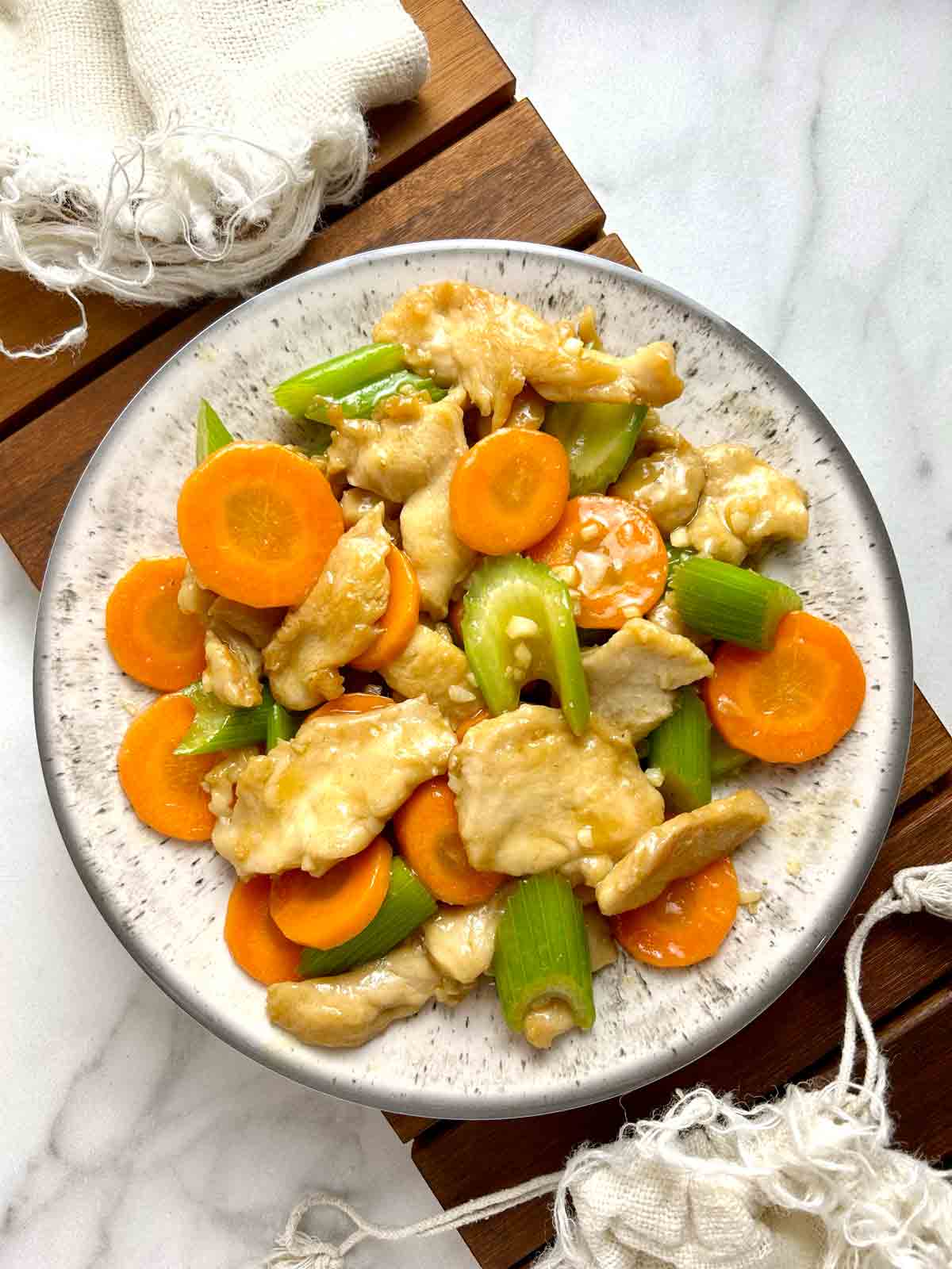 plate of chicken with mixed vegetables stir-fry.