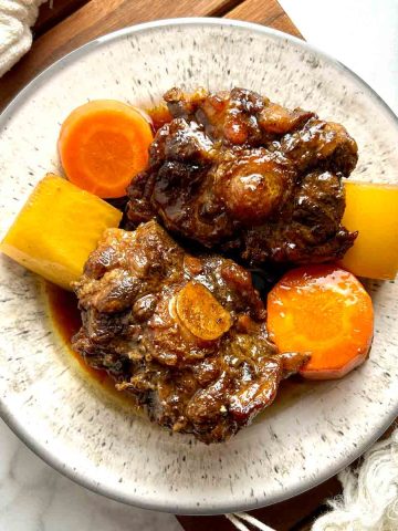 plate of braised oxtail with daikon and carrots.