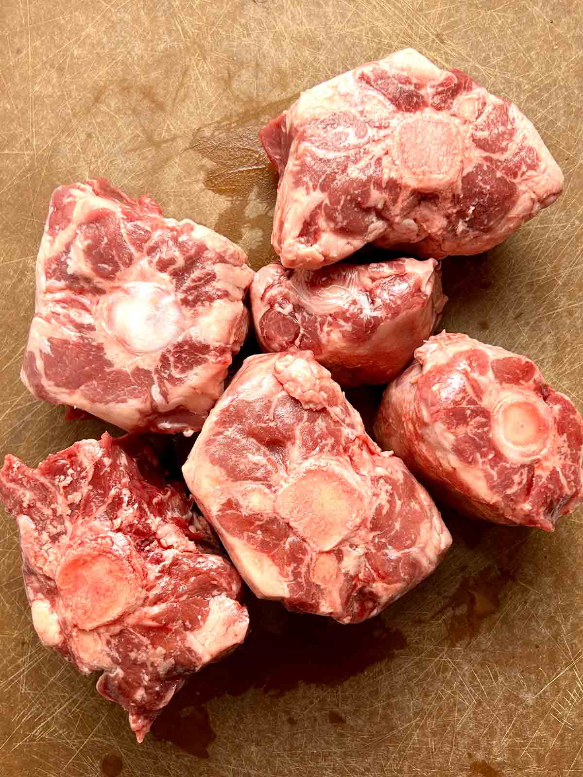 raw oxtail on cutting board.