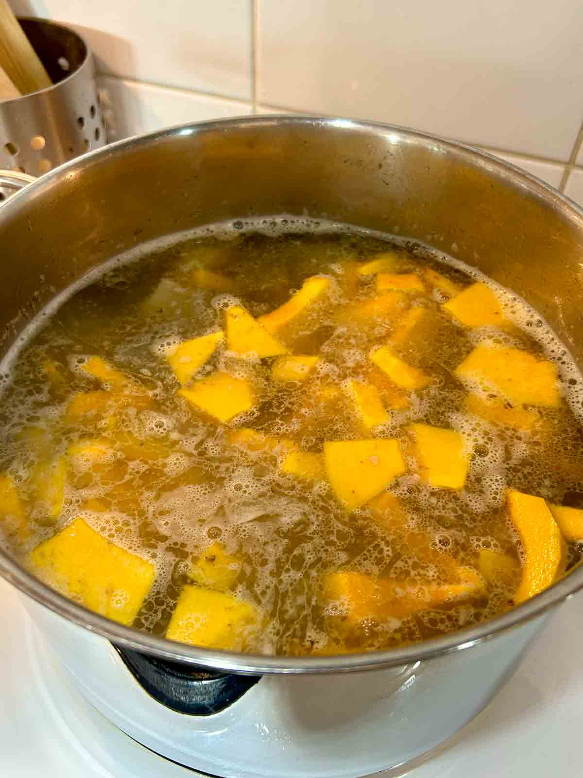 pumpkin added to pot of soup.