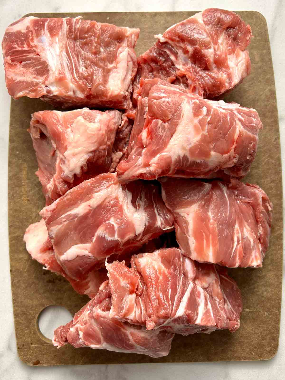 pork neck bones on cutting board.