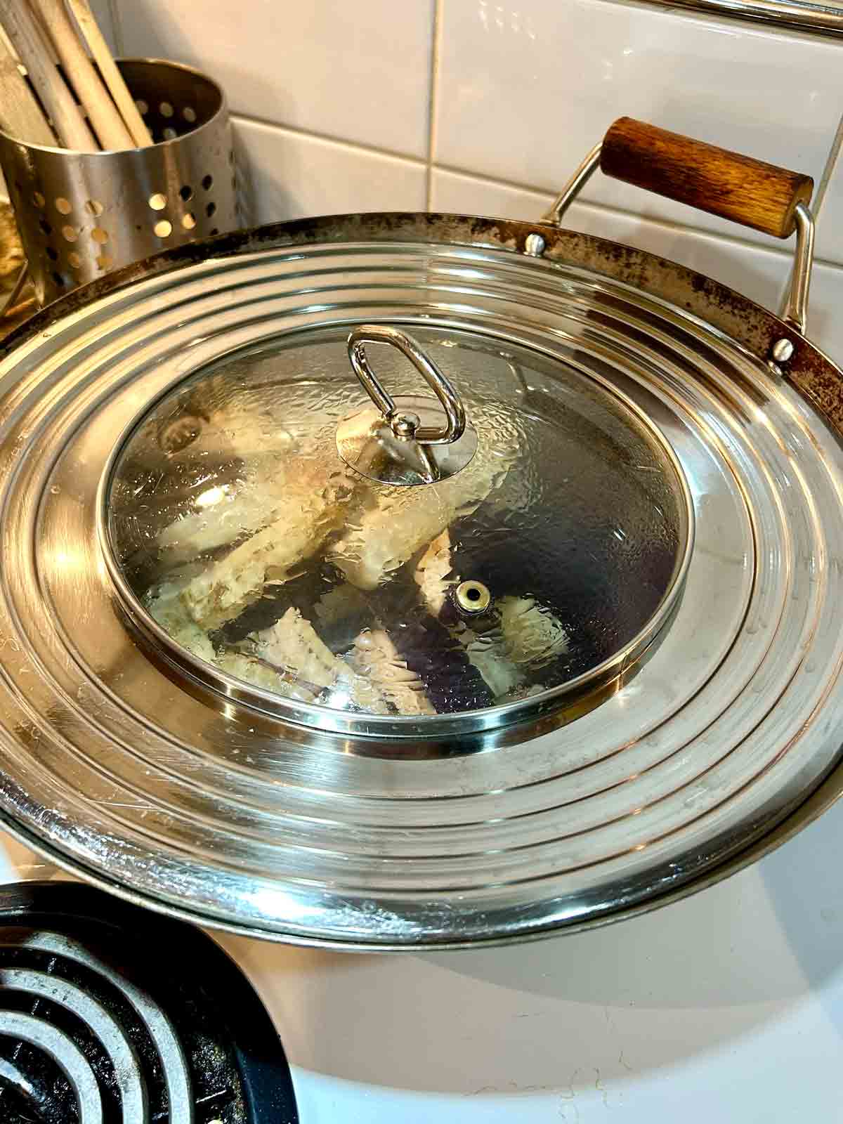 eggplant being steamed in wok.