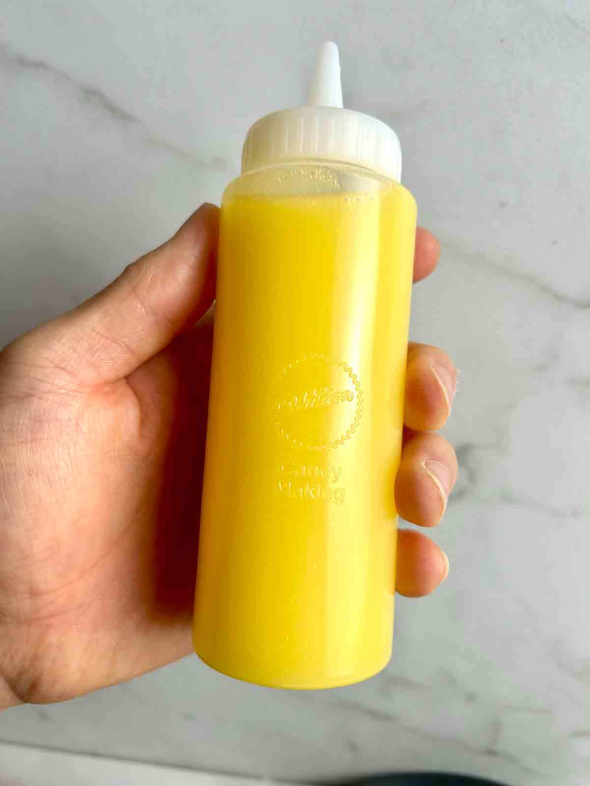 mango boba liquid in squeeze bottle.