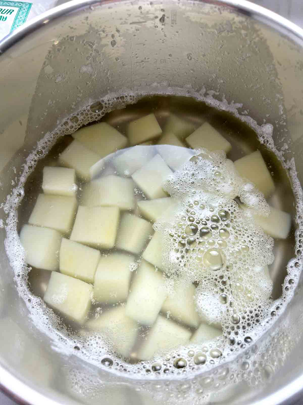 chopped potatoes boiling in water.