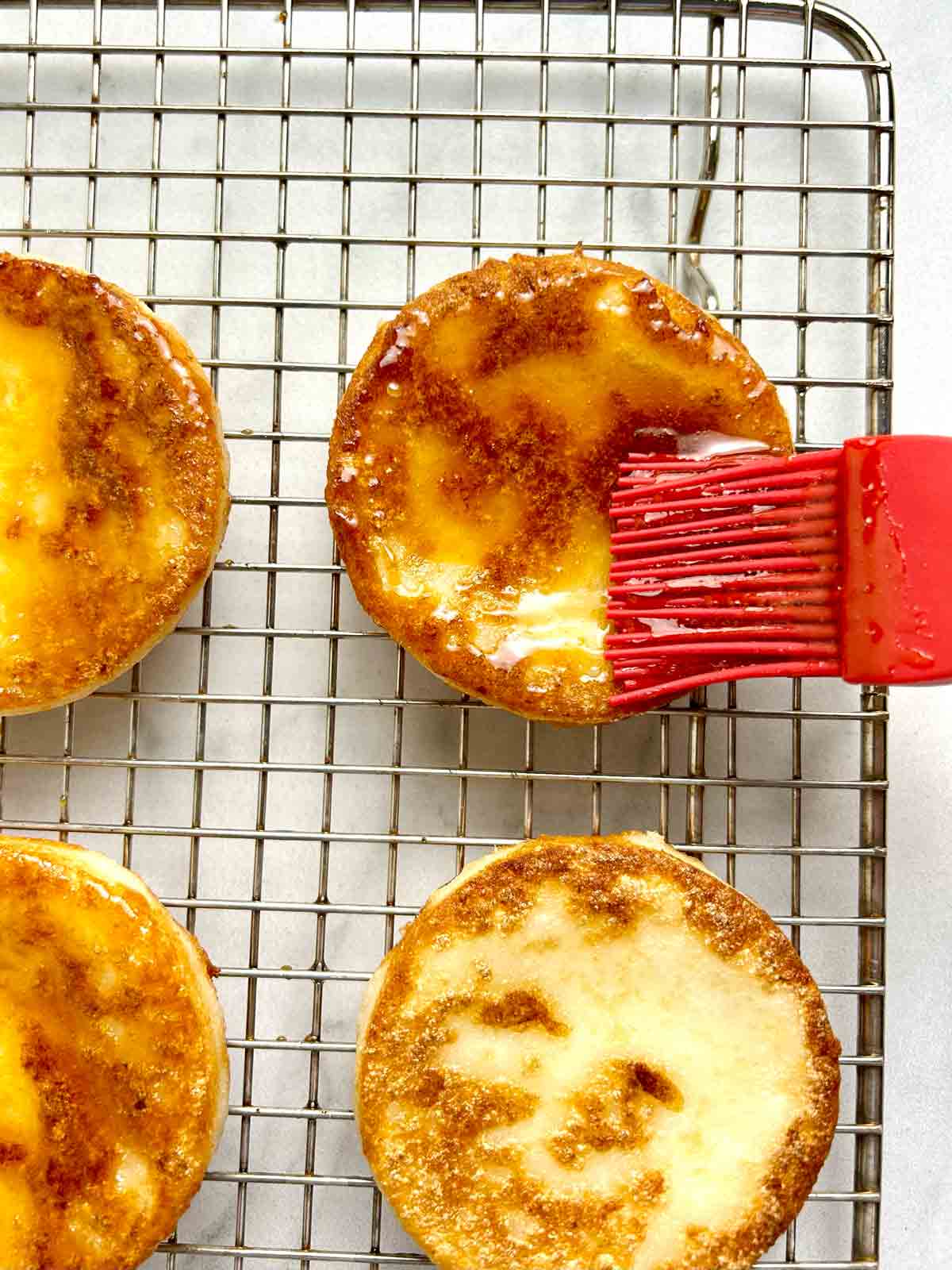 soy glaze being brushed onto potato mochi.