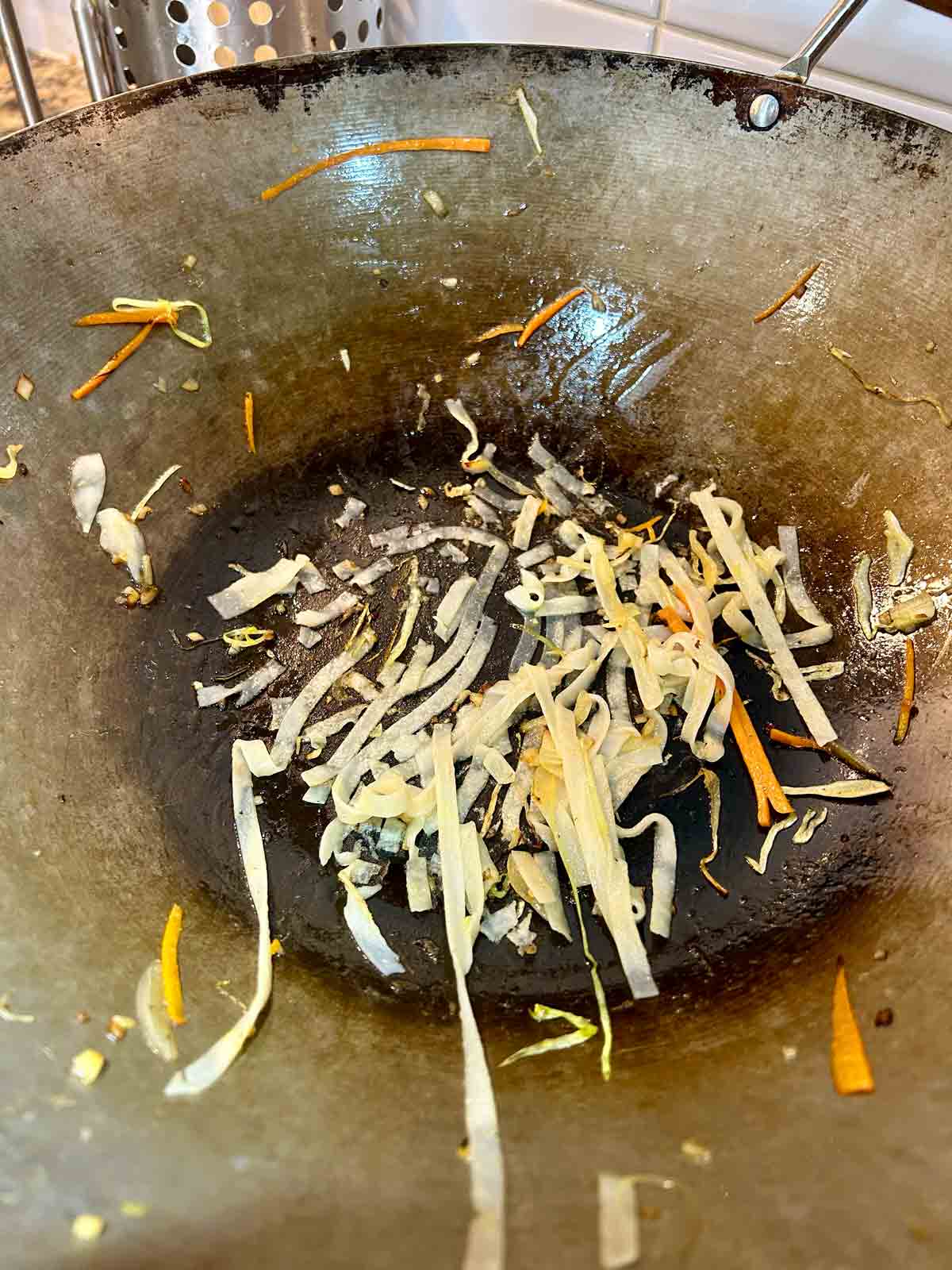 bits of rice noodles stuck on to bottom of wok.