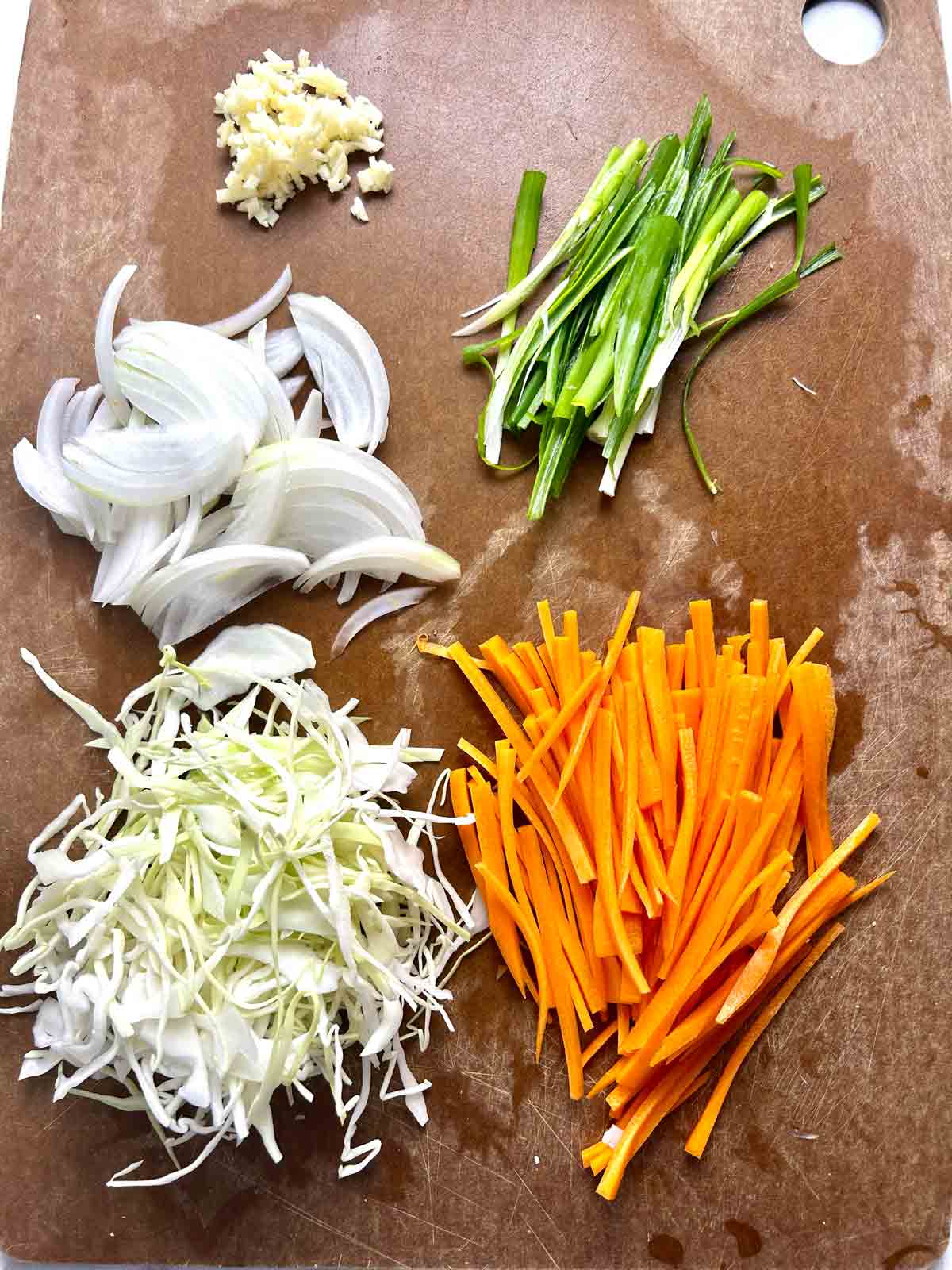 assortment of prepared veggies on cutting board.