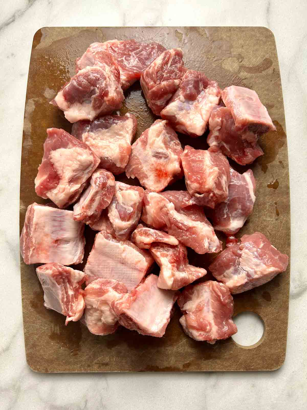 raw spare ribs on cutting board.