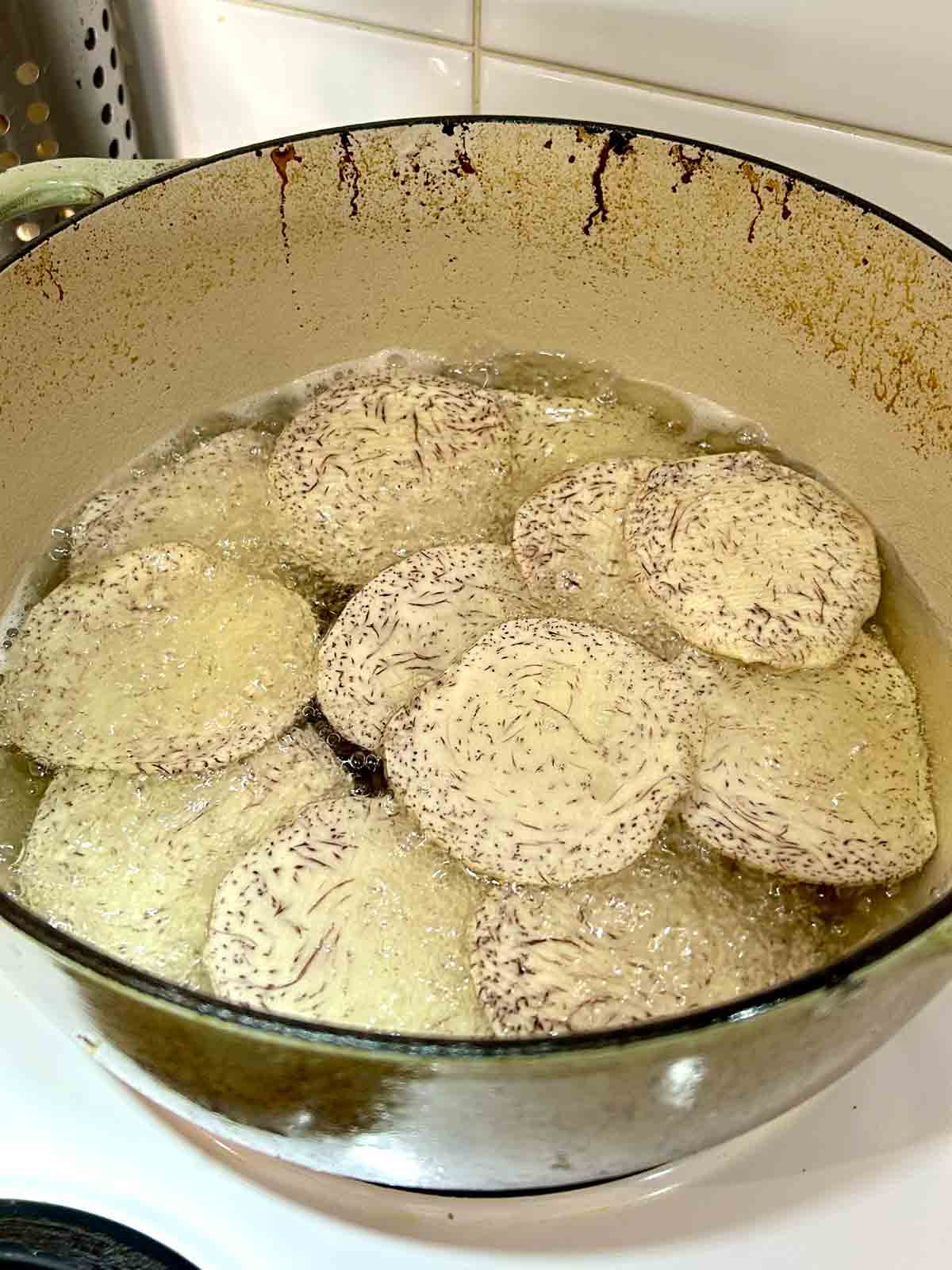 chips being deep fried in hot oil.