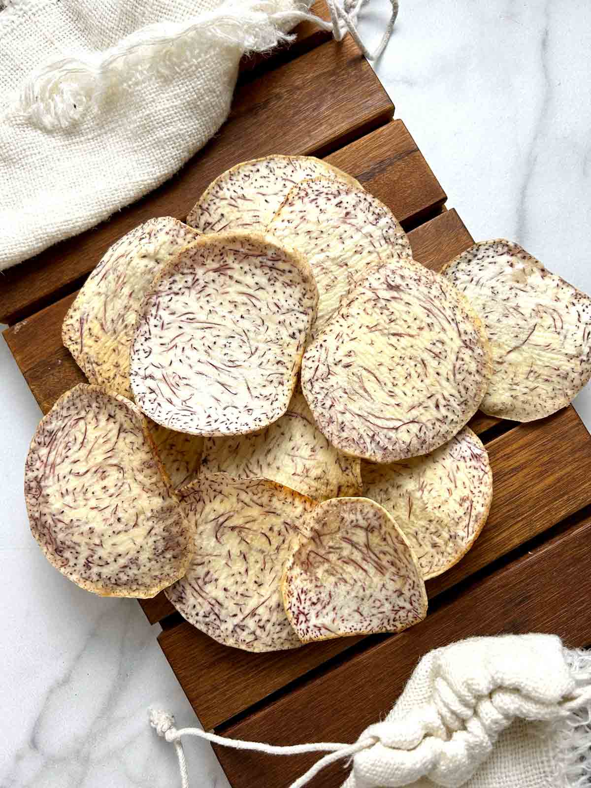 taro chips on wooden board.