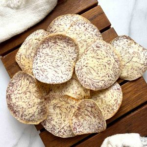 taro chips on wooden board.