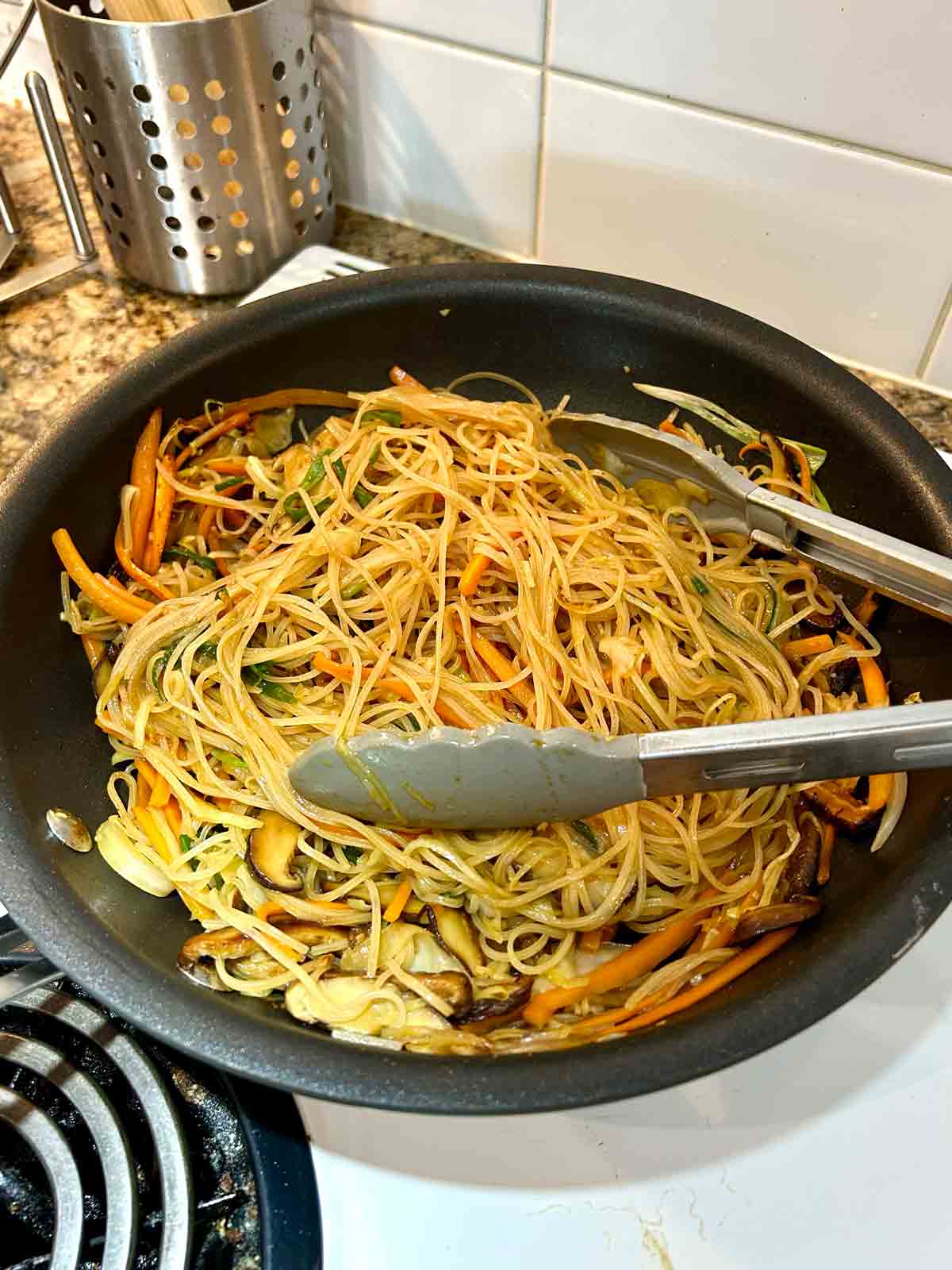 soaked noodles, sauce, and scallions added to pan.