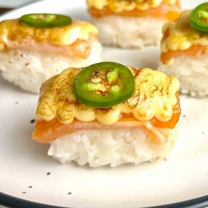 close up of aburi salmon on plate.