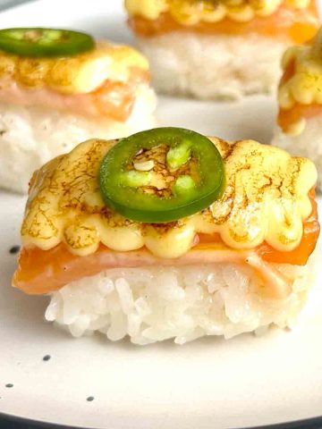 close up of aburi salmon on plate.