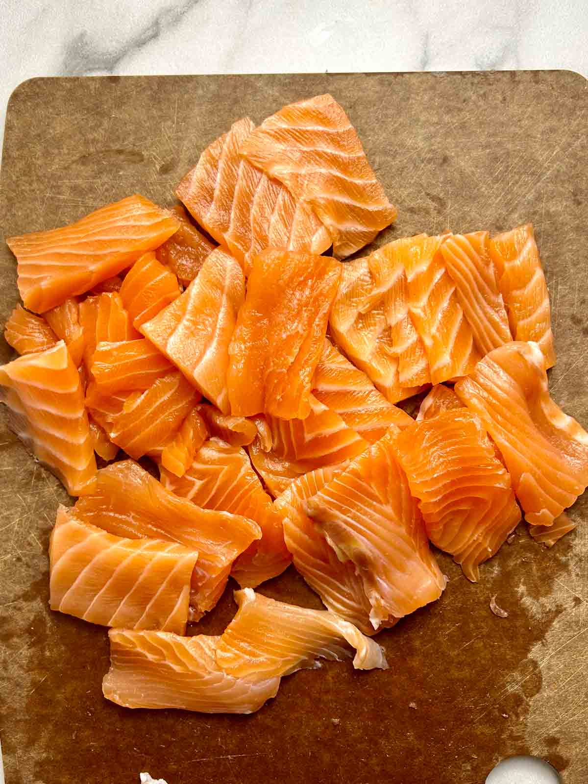 slices of salmon on cutting board.