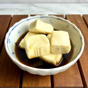 cubes of agedashi tofu in soy-based broth.