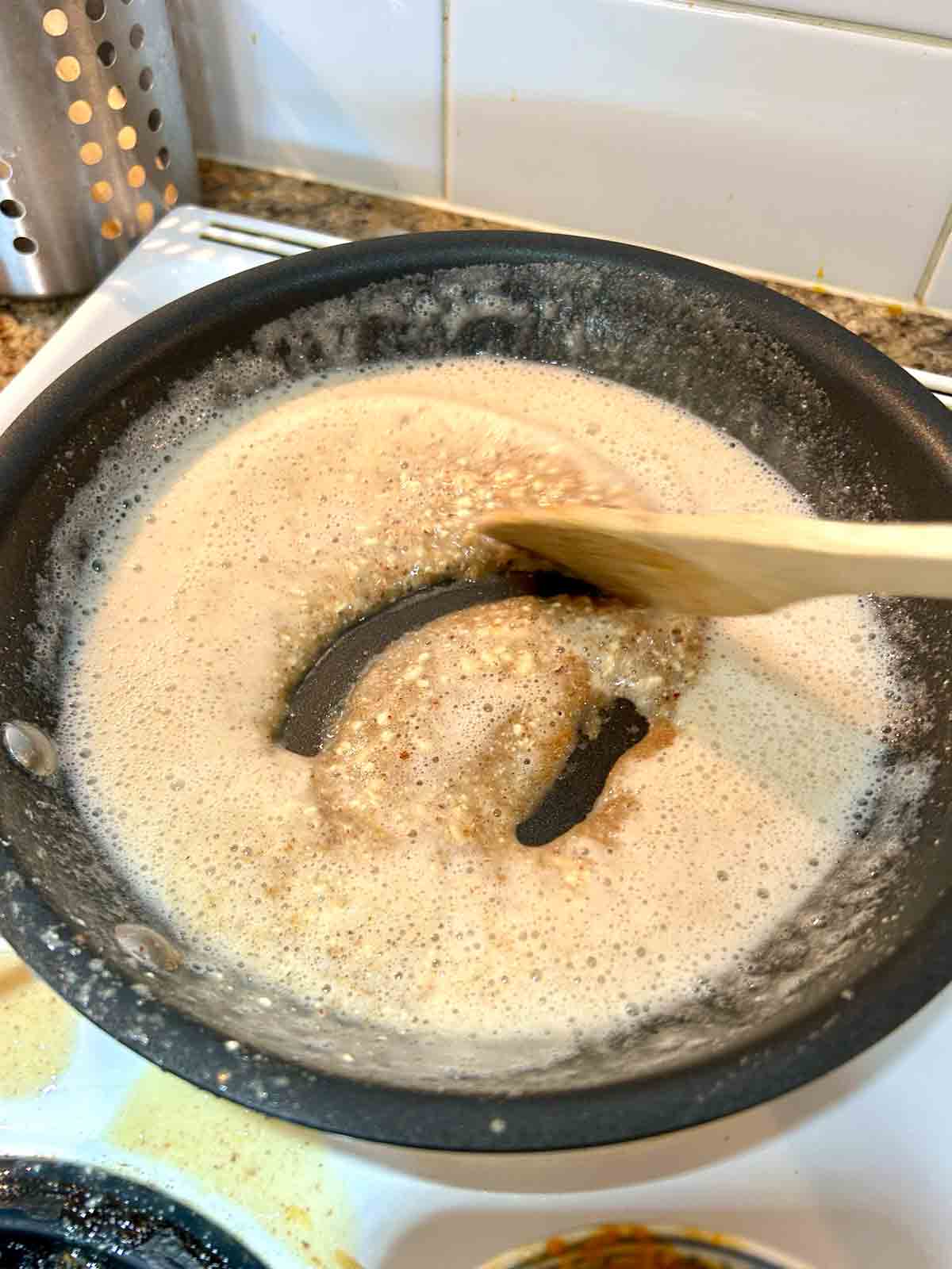 ground almonds and sugar being fried in oil.