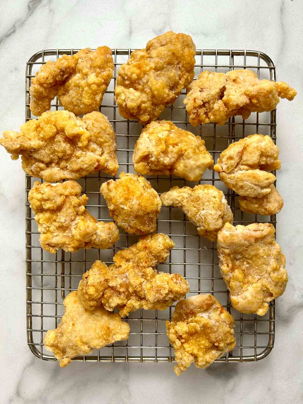 pieces of fried chicken karaage on wire rack.