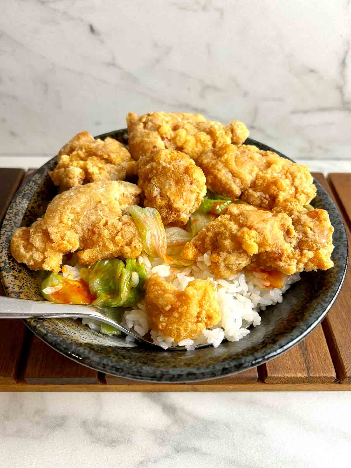 bowl of chicken karaage don with spoon in it.