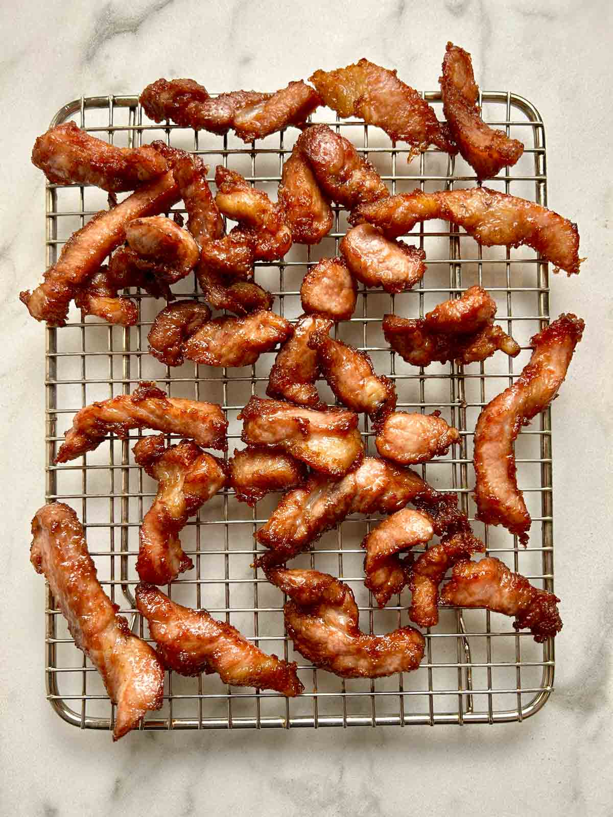 Chinese boneless spare ribs drying on wire rack.